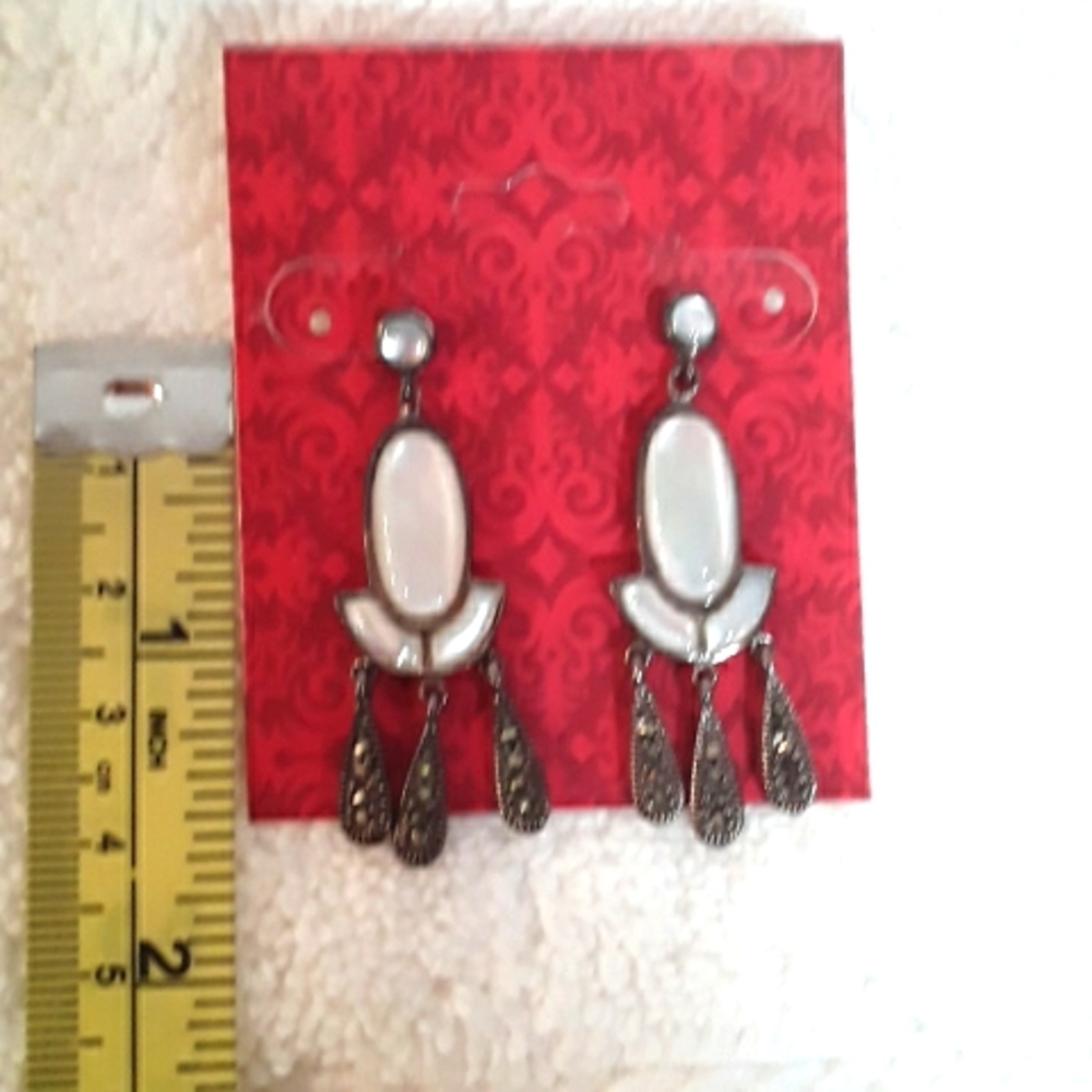 Genuine sterling silver post earrings in silver  marcasite with white abalone.